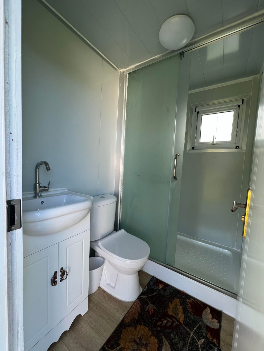 Private restroom facility with shower, toilet and sink