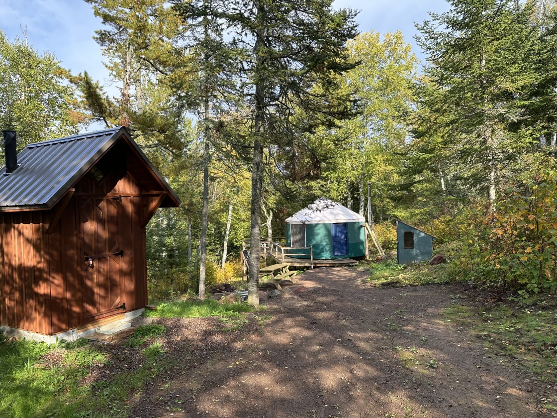 Yurt with deck and new biffy, leading down to lake