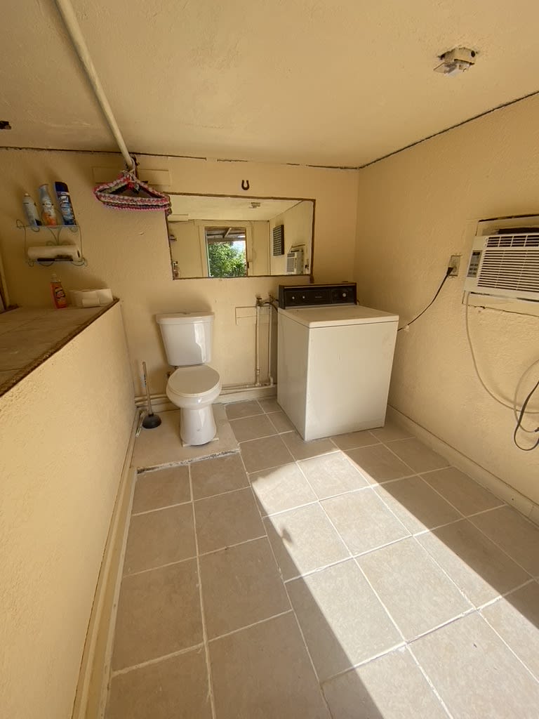 Shared, but private building housing toilet, washer and hot water shower.