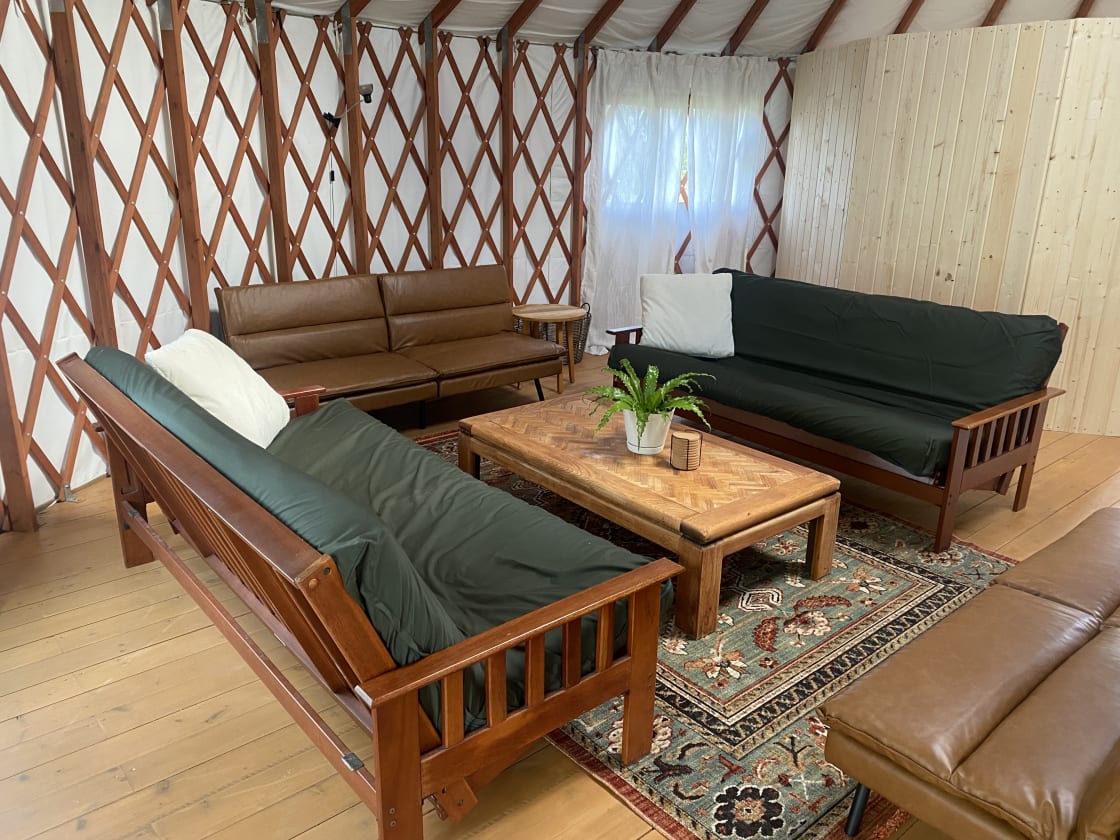 We've updated our look! We bought forest-green covers for the previous futons and bought two new futon beds. That pine wall is the new indoor bathroom. 