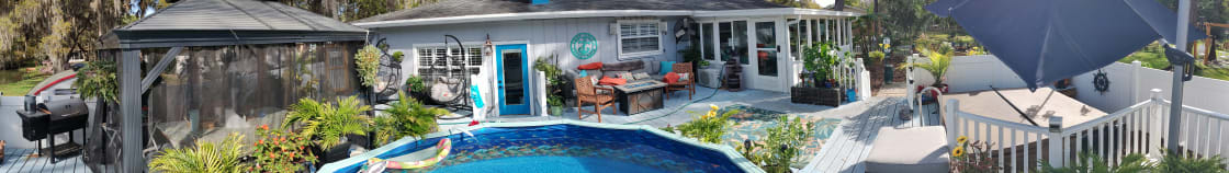 Tried to get some panoramic shots of the layout. L to R: the grill, netted deck dining set, pool and shower