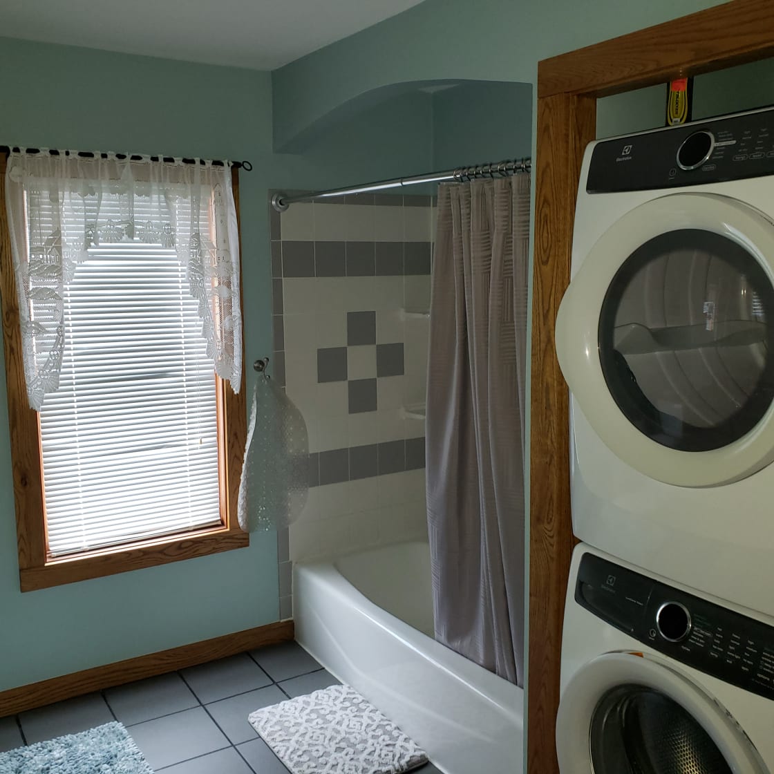 Tub shower and stacked washer/dryer