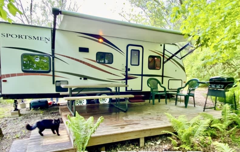 Early summer 2023 beautiful day at your camper with private deck, firepit, cave and waterfall. (Sometimes a dog or cat will visit you, so make sure your pet is always on a leash)
