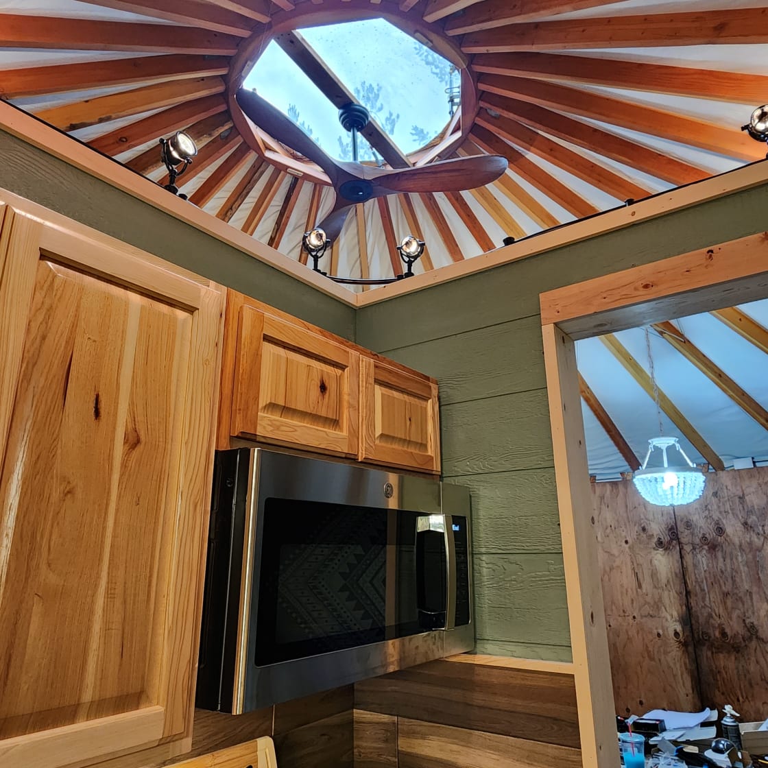 Remote controlled ceiling fan in yurt.