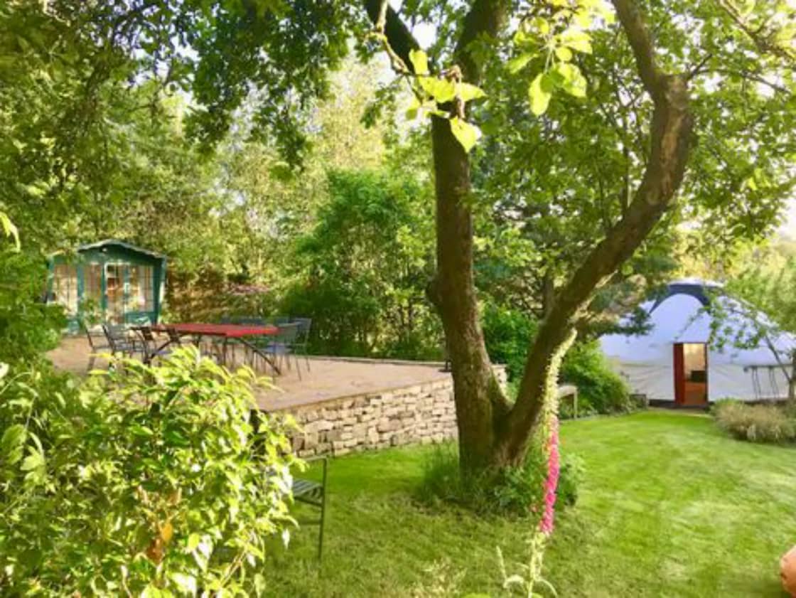 The two living areas are nestled into the garden. The yurt sits on a purpose-built platform & has electrical power points. The garden room looks onto the upper terrace with pizza oven, bbq, loungers. Hand-made table seats 12