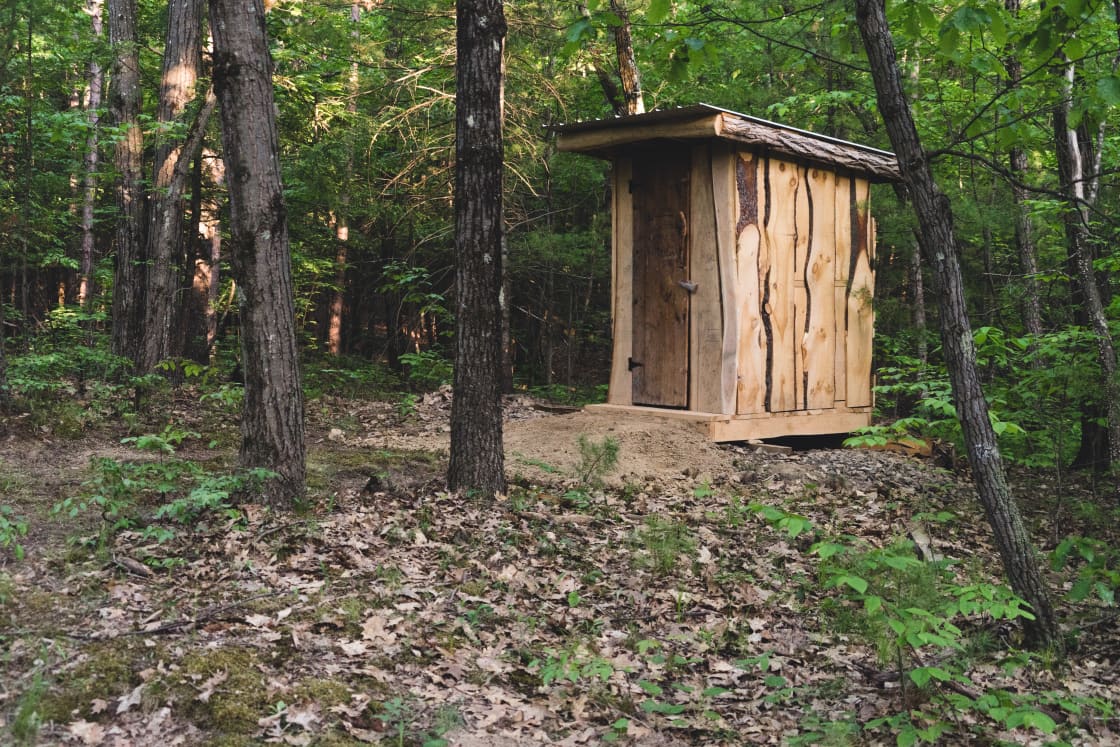 The outhouse still had that fresh-cut wood scent.