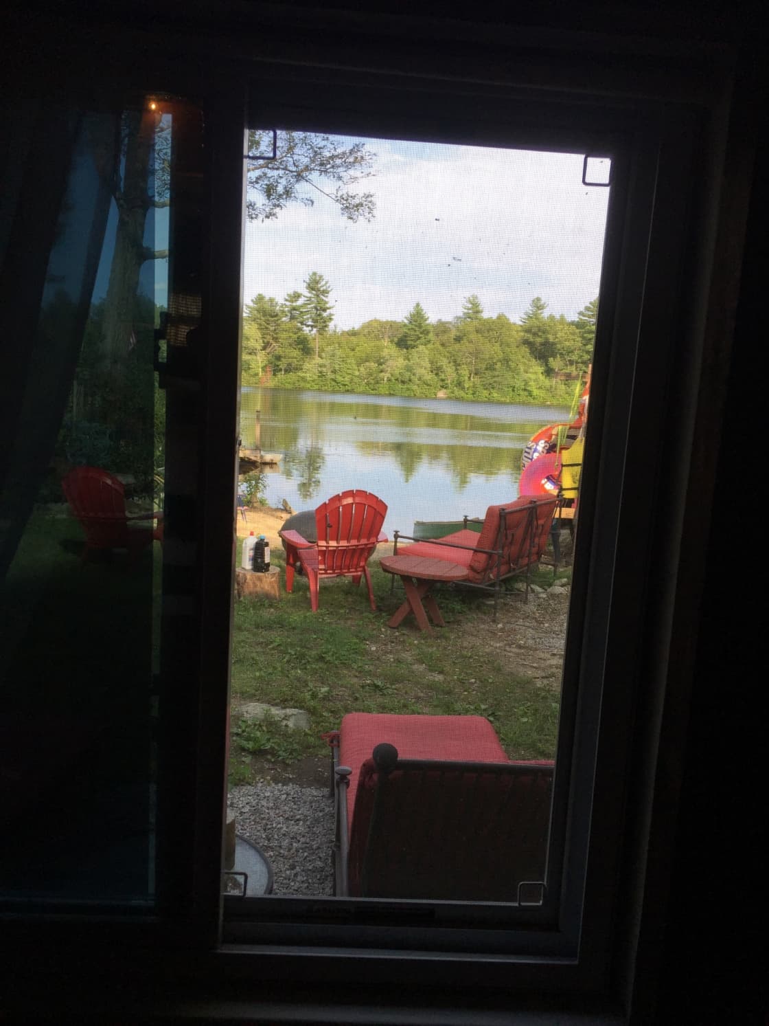 view from inside camp out to water and fire pit in back yard