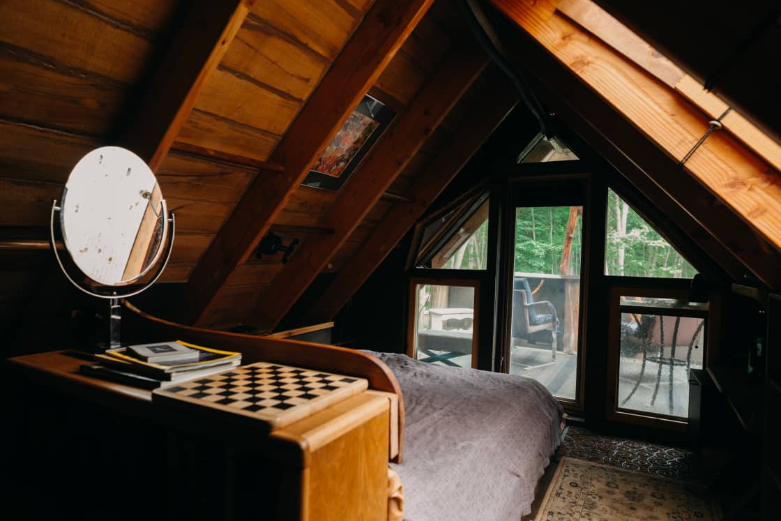 The main room in the loft with a deck overlooking the forest.