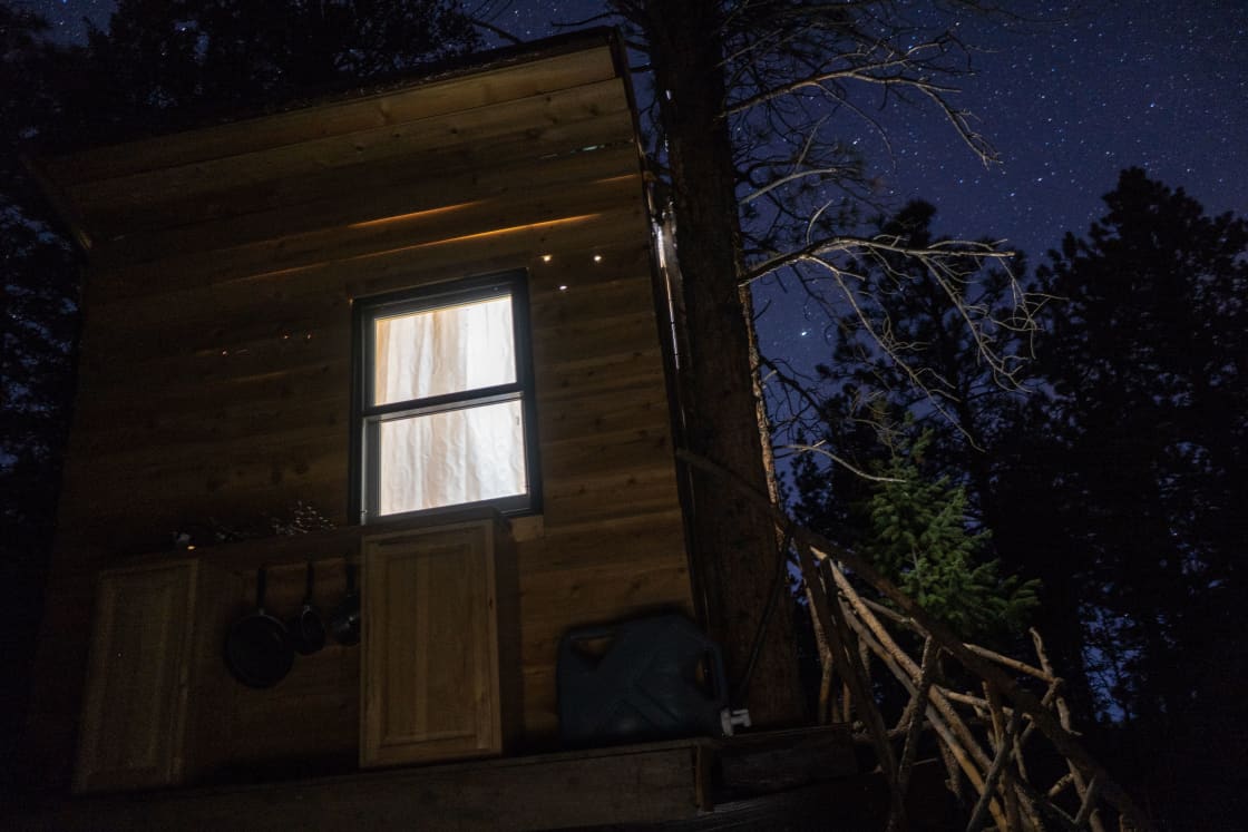 A profile view of the Cabin at night with the brilliant night sky