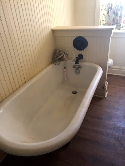 1938 clawfoot bathtub that now has a shower curtain surrounding it so you can spray away with the shower...everthing in cabin is old or antique!