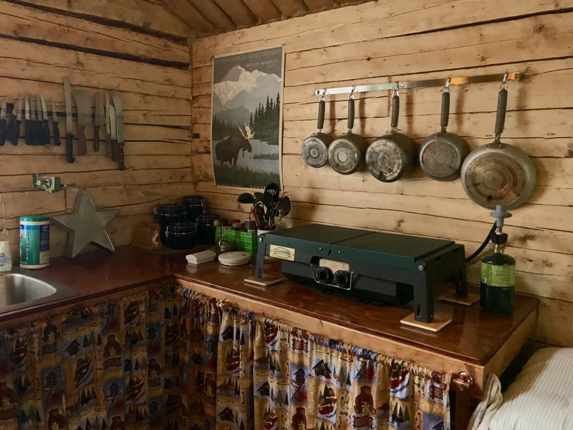 Log Cabin is equiped kitchen with camp stove, dishes, utensils, pots and pans and camp sink.