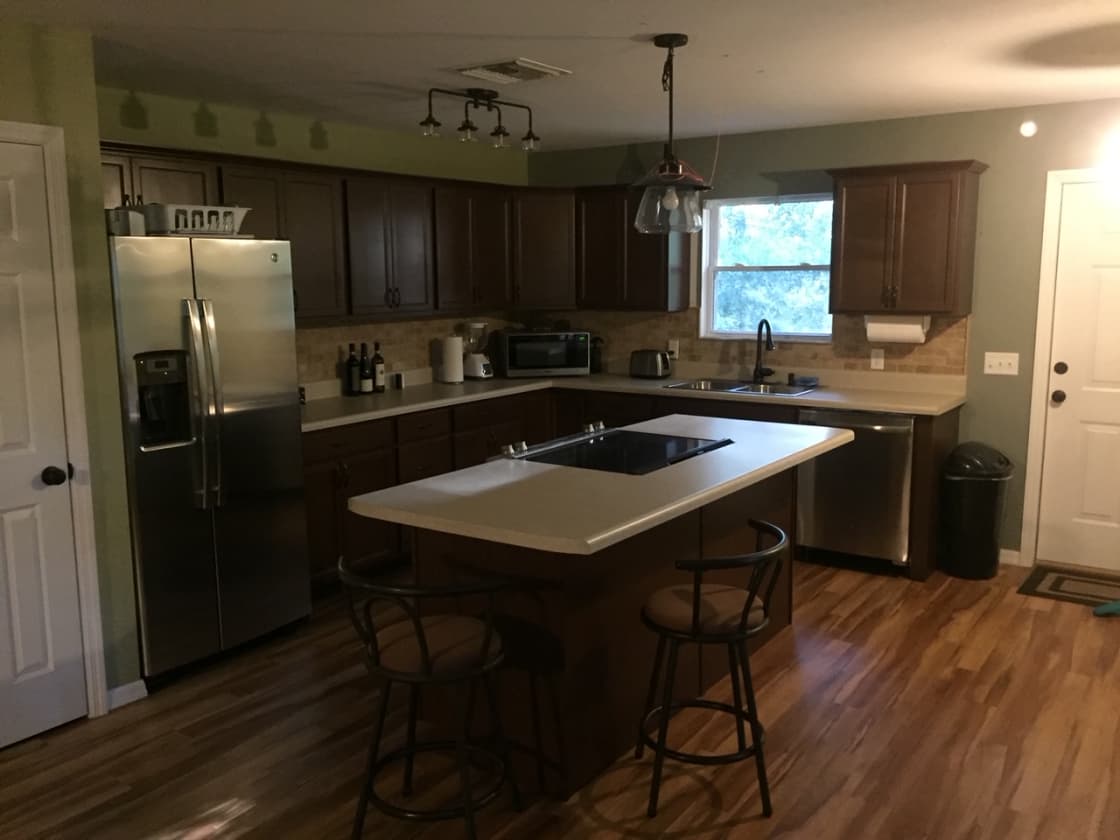 Fully renovated kitchen complete with an island and all the utensils needed to cook a meal. 