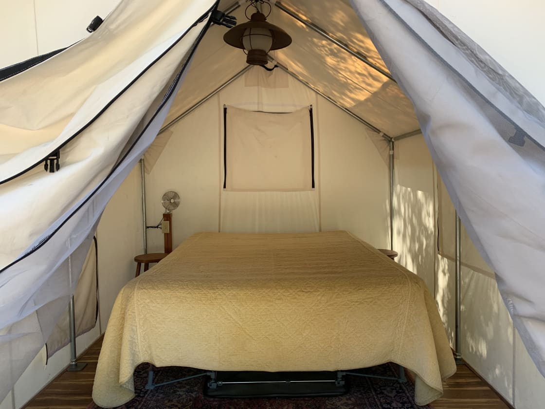 Inside of tent with queen air mattress.  Bring your sleeping bag, and pillows.  Overhead light and 12 volt fan.  Three windows to zip open or closed.