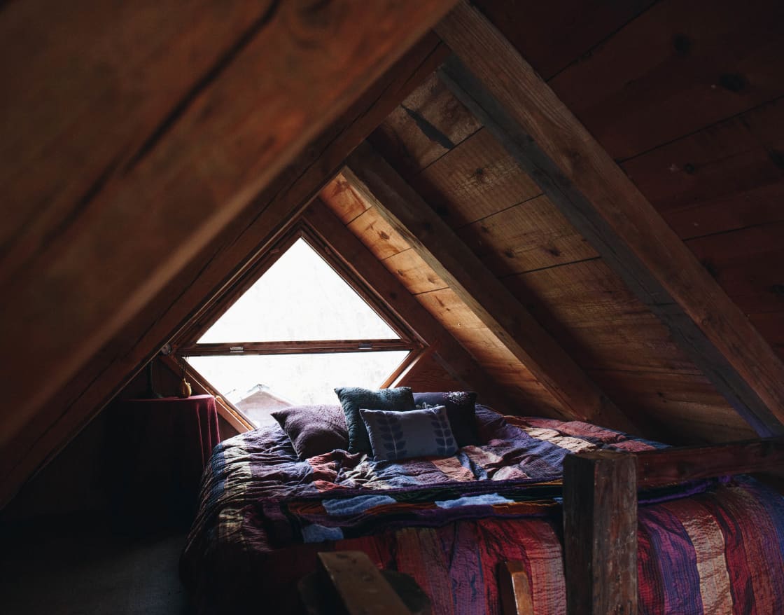 Loft-style bed at Stone Ridge Tiny House