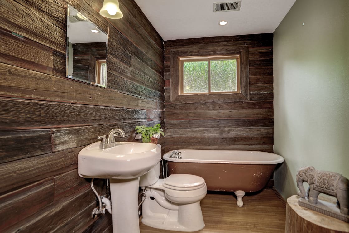 A cozy, rustic bathroom with a clawfoot tub to soak in at the end of a long day of exploring the Rocky Mountains.