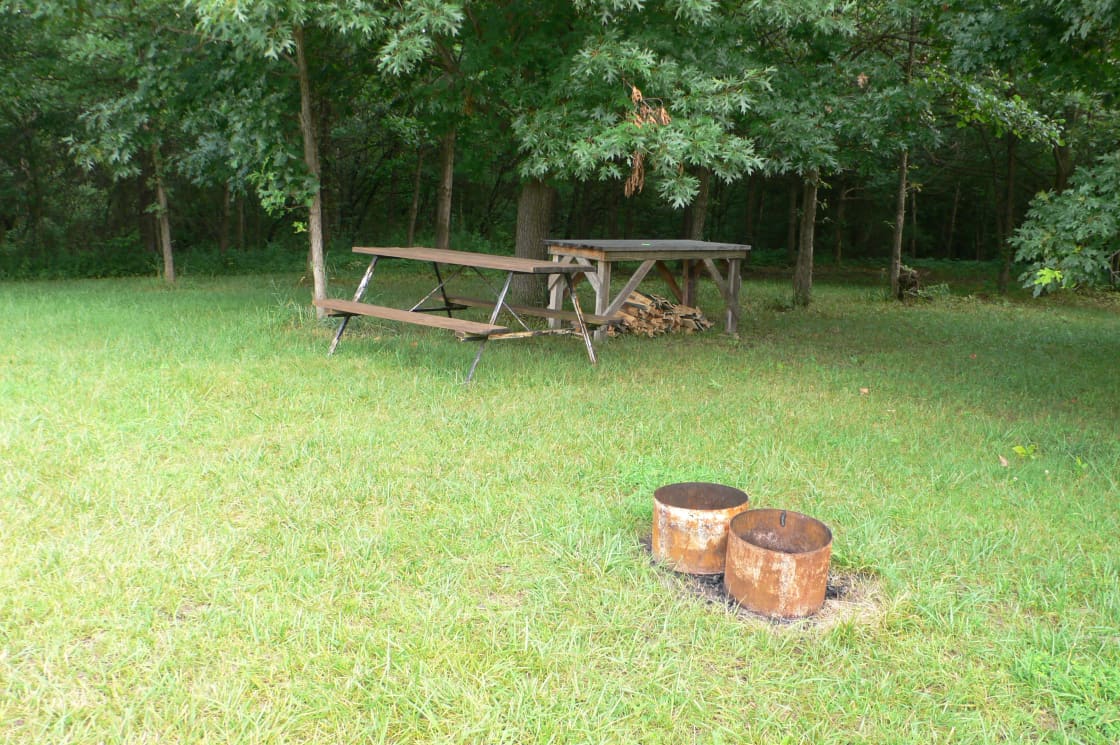 This is what the campsite looks like.  We have a picnic table and a food prep table in the shade.  We have two small fire rings and grates for cooking.  We hope to add a larger fire ring.