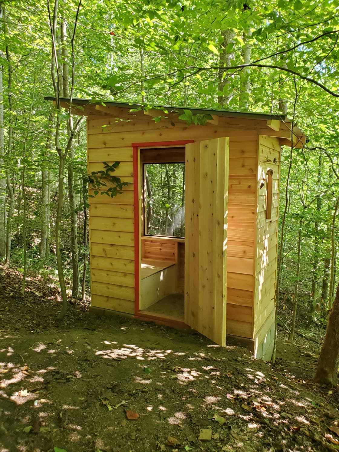 The outhouse, featuring a dry composting toilet.