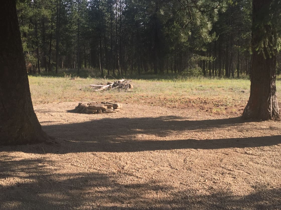 The RV spot and surrounding area is graveled, including the fire pit.