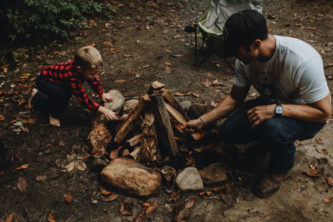 my brother & his son building a campfire for the night 