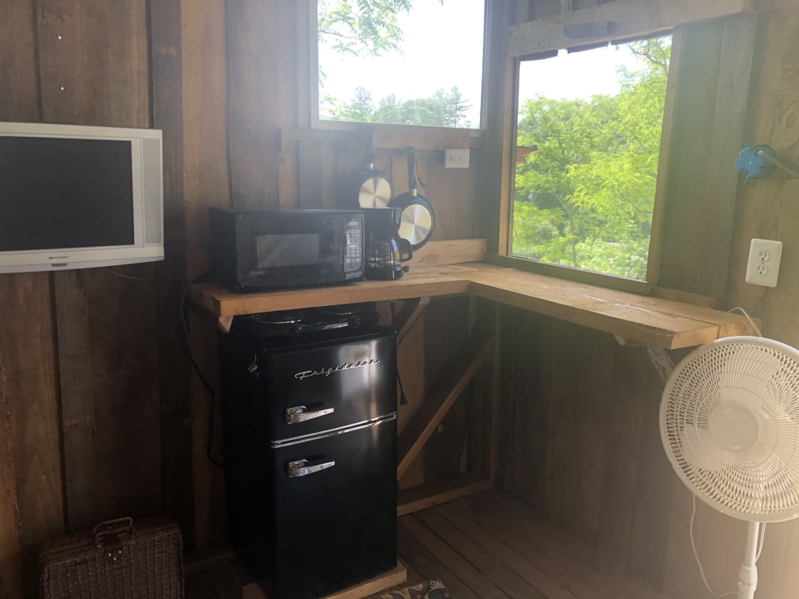 The shack is furnished with a dvd playing tv, mini Refrigerator, hot plate with pans, and a microwave.