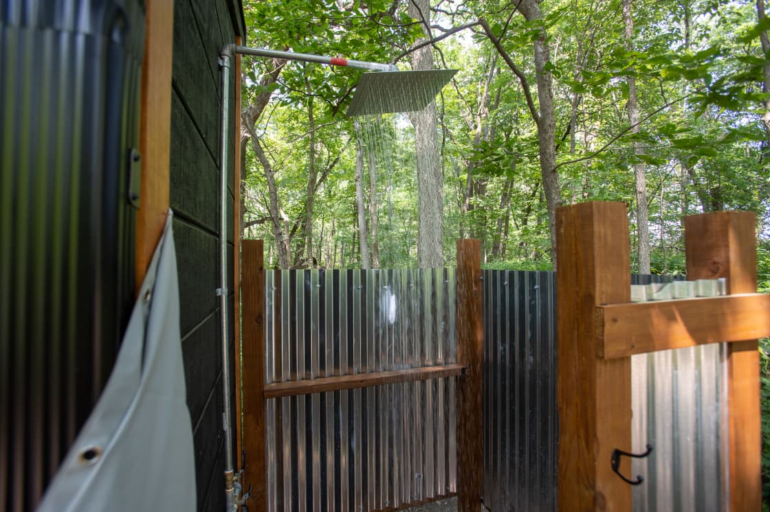 Outdoor shower surrounded by trees