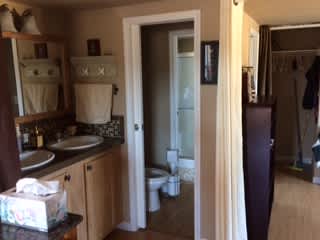 Double sink area separated by door from Toilet and Shower areas.