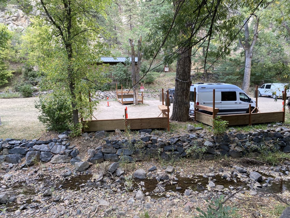 Vanlife campsite with creekside deck