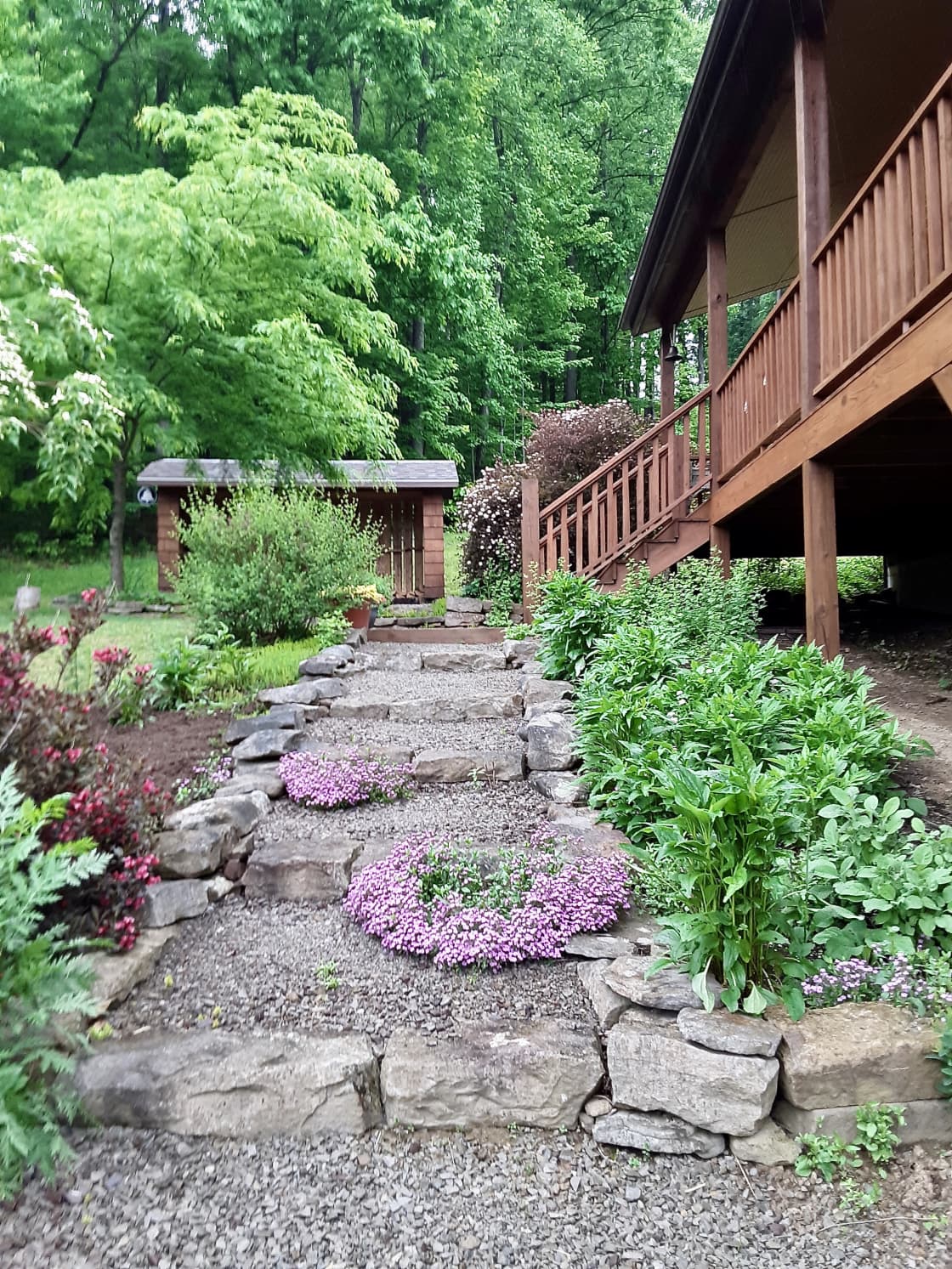 Steps lined with herbs and flowers lead from the driveway to the apartment.
