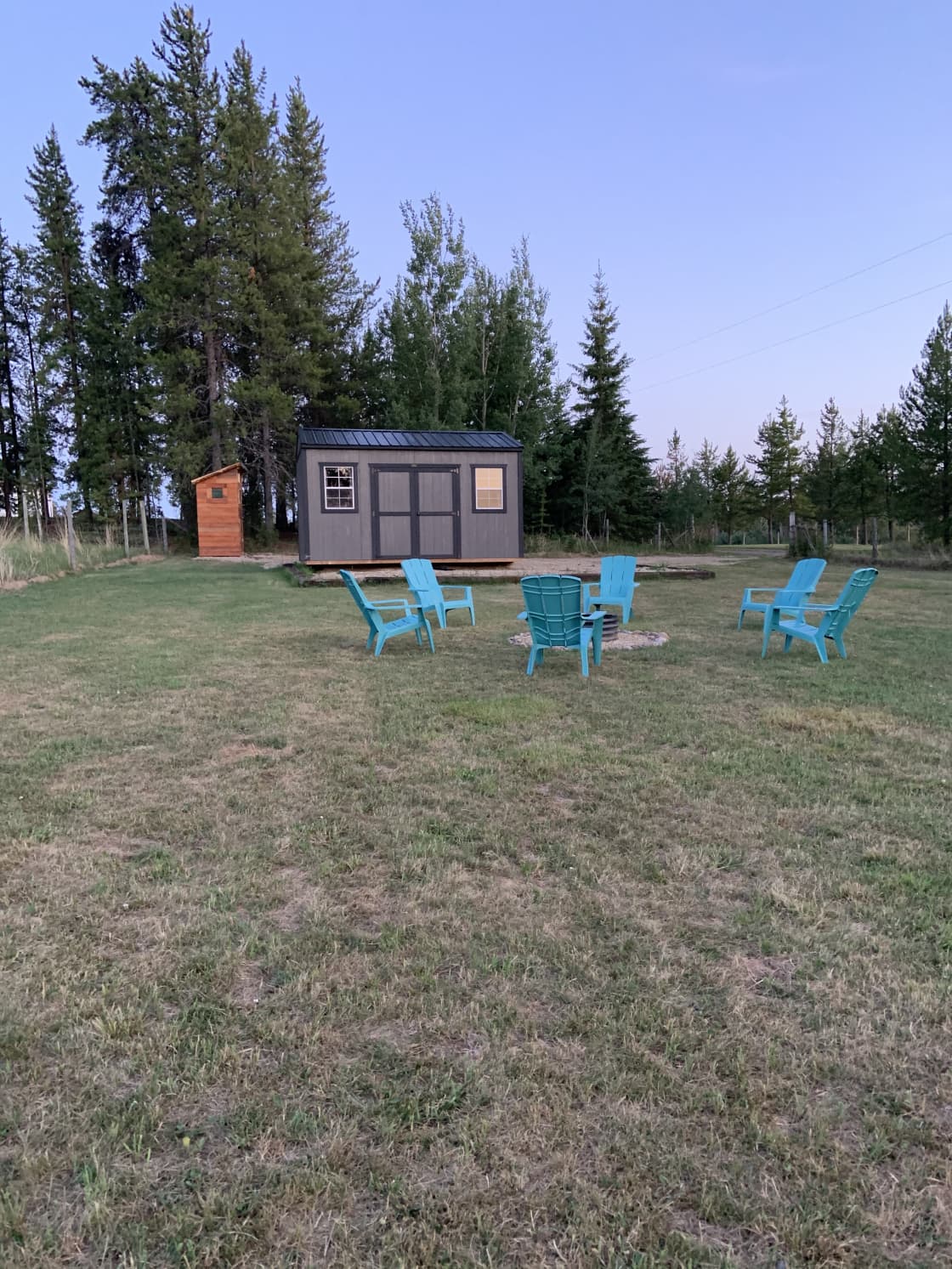 South facing view of campsite; gravel parking pad behind the cabin.  RV or tents welcome anywhere on the grass.  Behind the tree line with plenty of privacy; your host house is on the south side of the land.