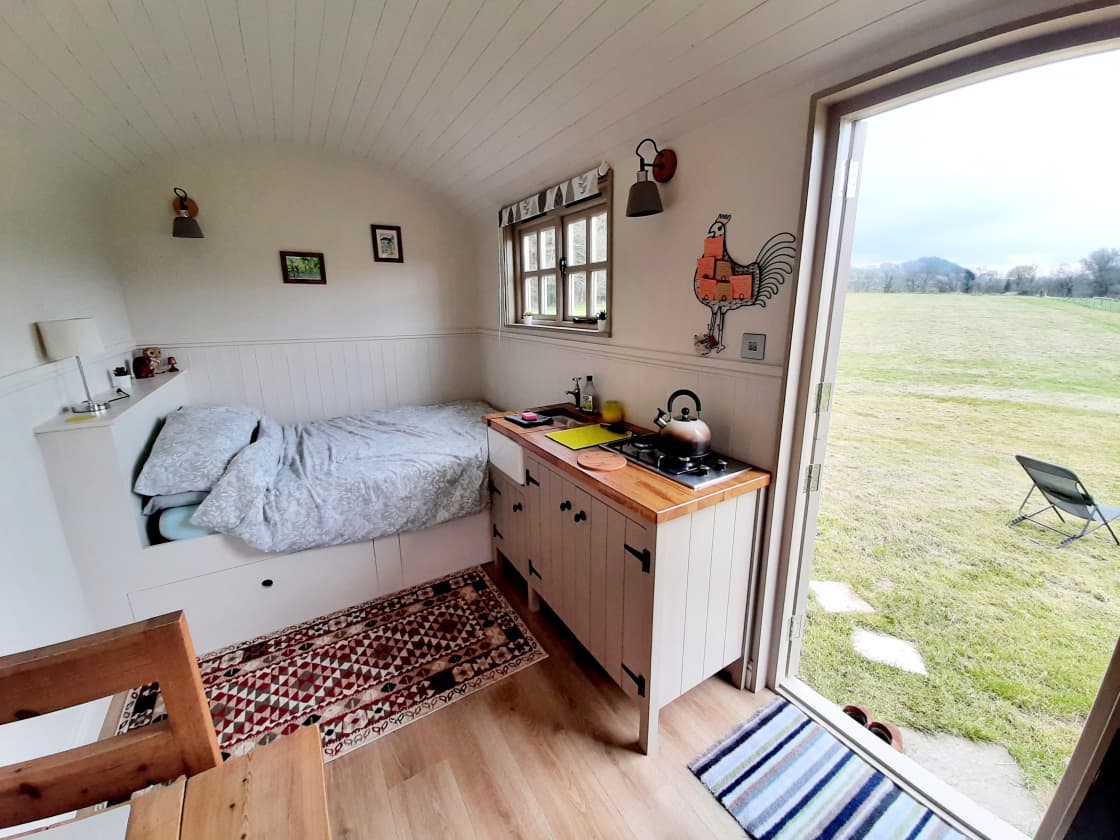 Inside our hut you have a double bed, kitchenette and dining area plus a cute log burner to keep you warn in the evenings.
