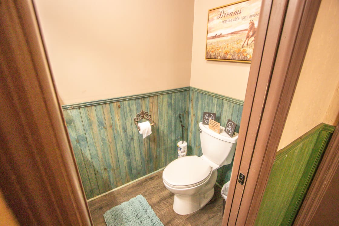 There is a spacious bathroom in the outdoor entertainment area with a sink.