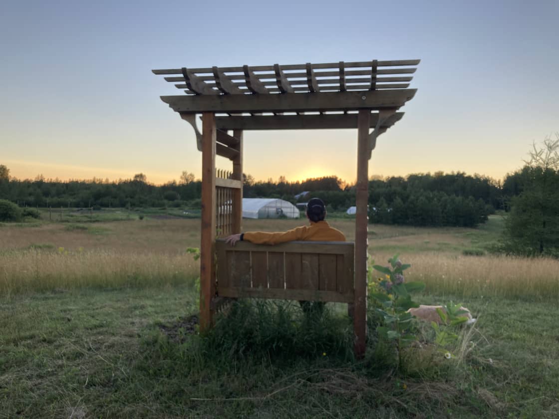 Take in the beautiful sunset views of our farm fields from our hilltop pergola bench.