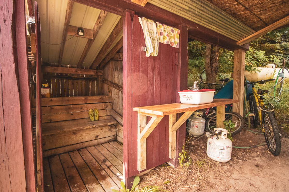 Outside the shower is a dishwashing station with everything you could need