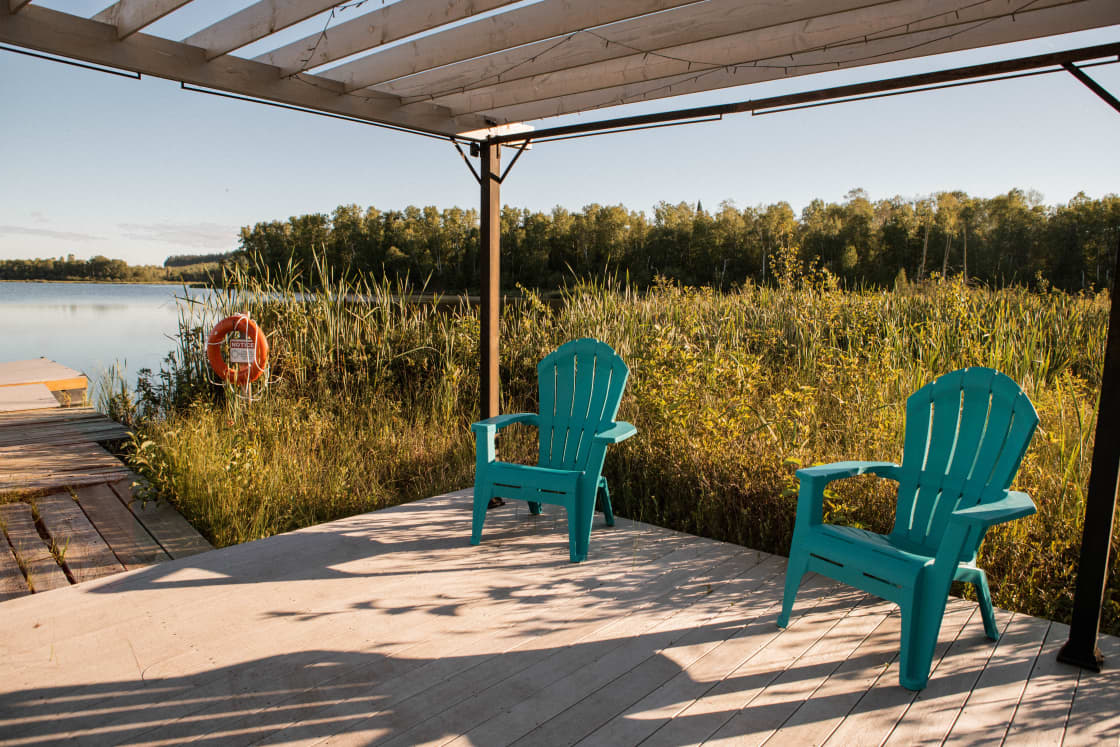There is a pergola area with 4 chairs at the end of the boardwalk. 