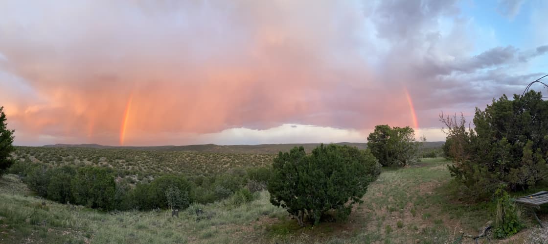 Partial rainbow and evening light on virga to the east over the adjacent wilderness area.