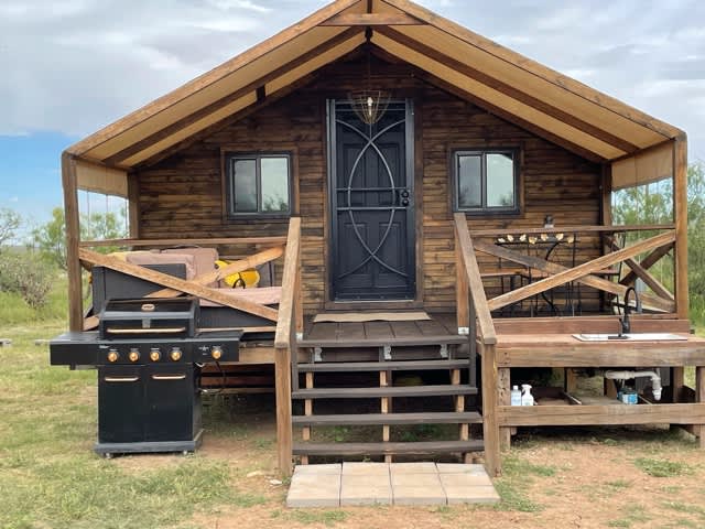 Canvas Cabin Glamping! Large outdoor grill, sink and prep space. Dinning set for 4 and large outdoor sectional sofa. Need to keep movin'- no worries you will find a slew of outdoor games including a regulation size corn-hole set. 