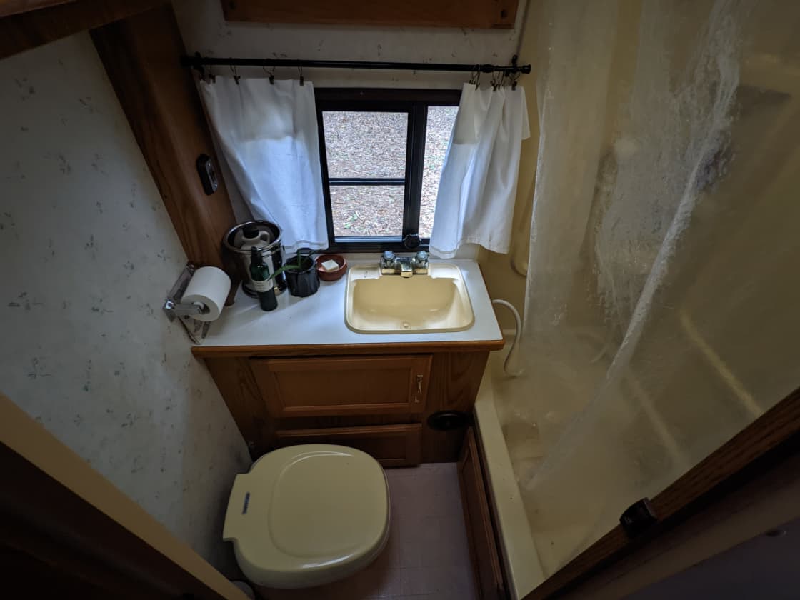 Bathroom with flush toilet and sink.