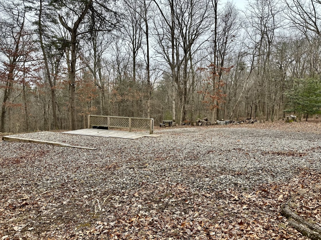 Gravel RV pad w/WiFi, full hookups (30 amp electric, septic, city water), trash bins, picnic table, fire pit, deck, and 8 acres to explore