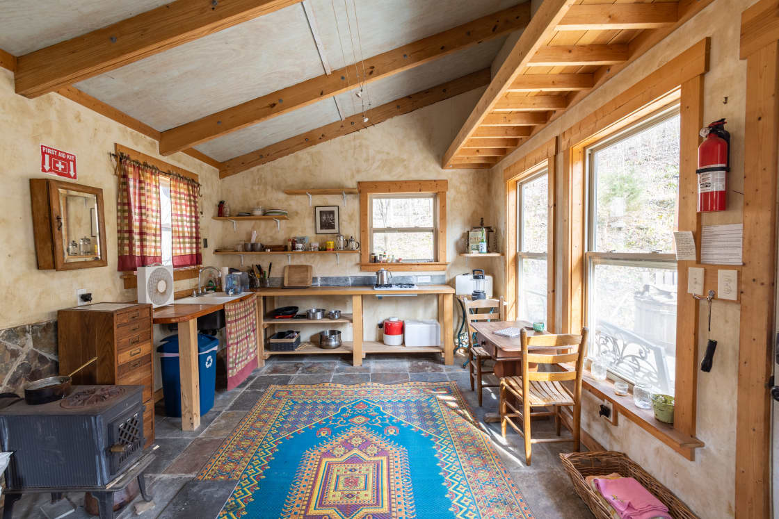 The tiny home has a propane stovetop for cooking and wood stove for heat.