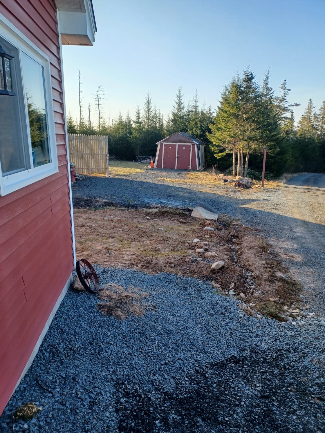 If you have a RV, it can fit right up against the red shed where the orange cone is located in this pic.  The longest RV I've had in this spot was 33 foot, plus the truck. I do not recommend anything longer then 33 foot.  A long extension cord runs from the garage (which is to the left in this pic) to where the RV is parked
