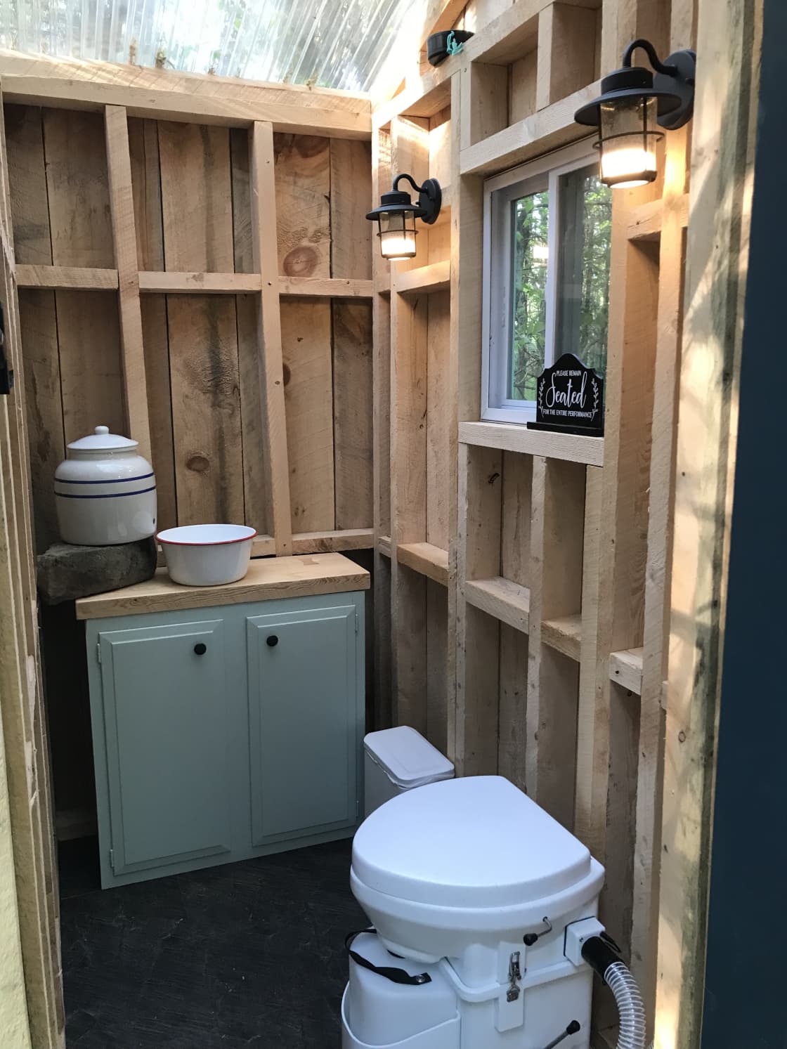 Bathroom with compost toilet and hand washing area.