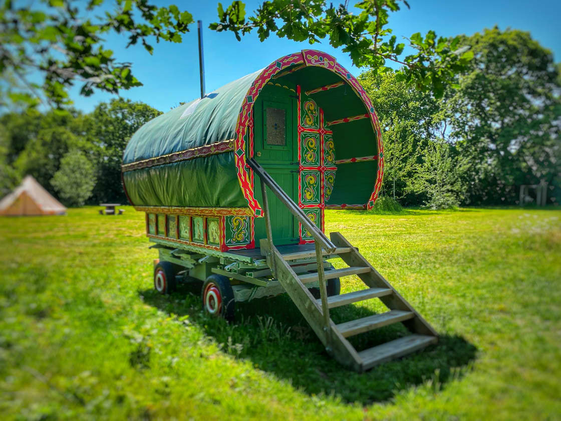 Immerse yourself in a world of enchantment and tranquility with our captivating green bow top caravan, offering a unique and picturesque retreat that promises an unforgettable camping experience.