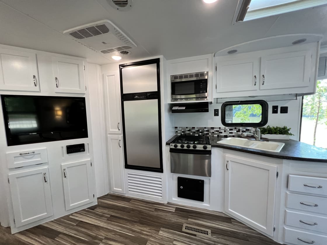 Kitchen with refrigerator and microwave