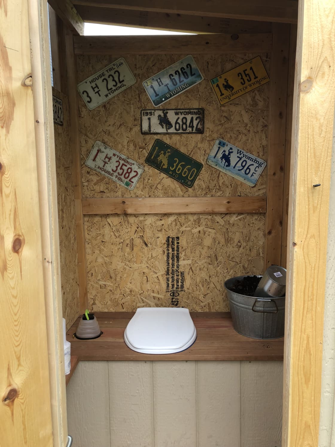 Composting toilet. Please take a seat. Add a little scoop to the bucket if you added solid waste.