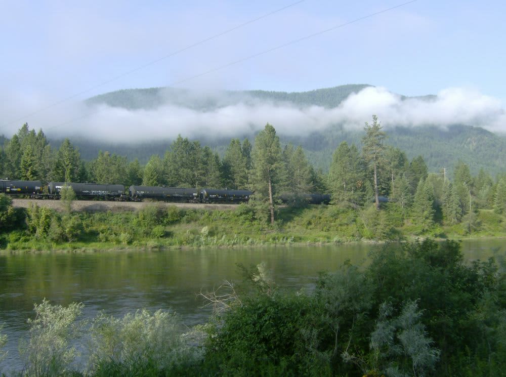 As seen from campsite: river, low clouds, and passing train.