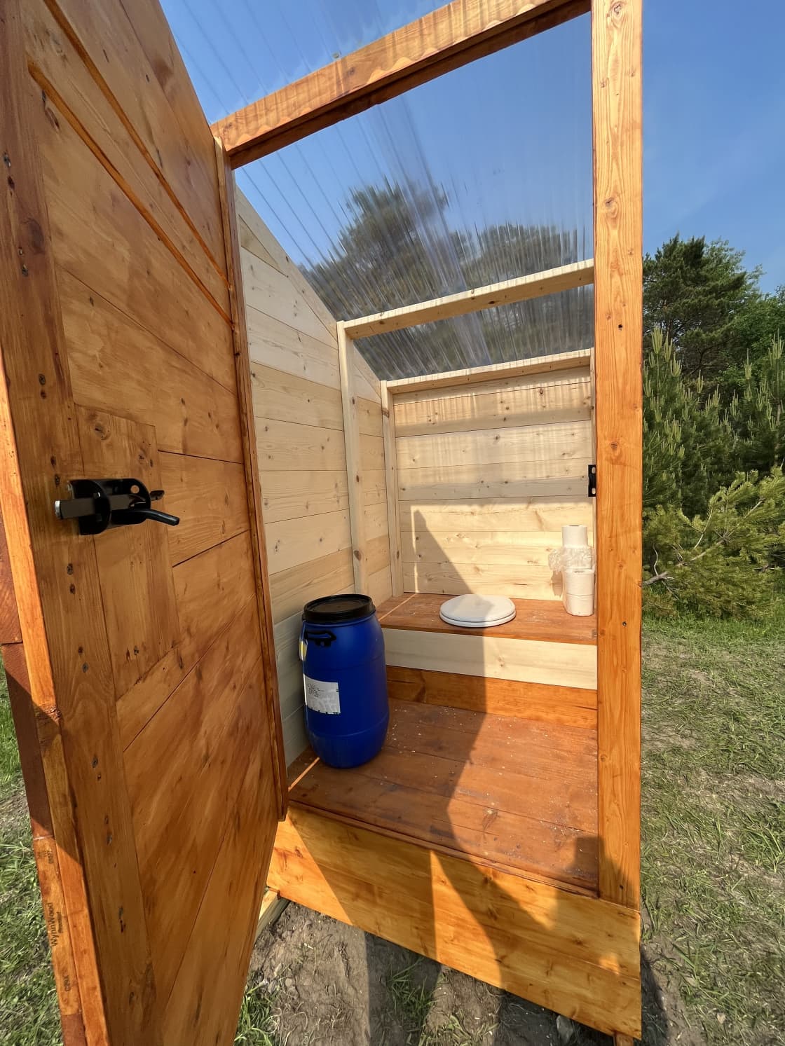 Interior of composting outhouse. Blue barrel holds the sawdust.