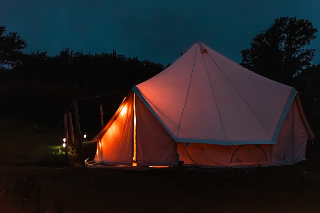 Solar lighting provides visibility at night all around and inside the tent, as well as all the main paths