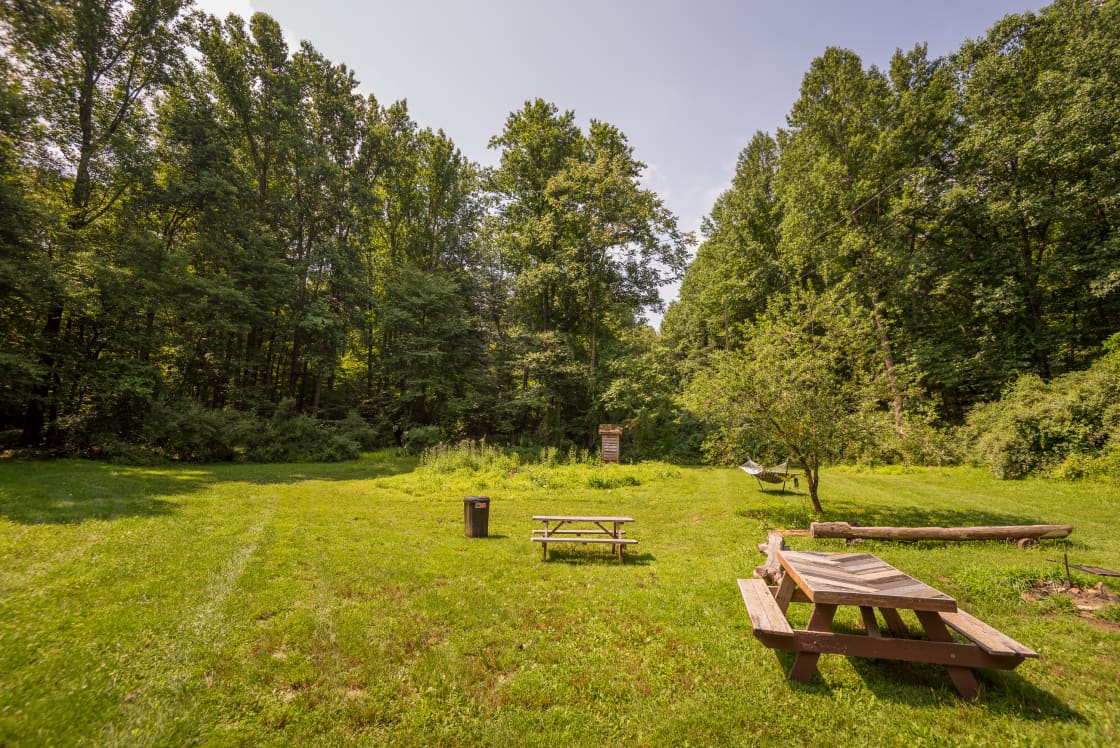 Site #2 is a huge site with a ton of space available for a large group. It has a private outhouse, hammock, firepit, and entrance into the woods for hiking.