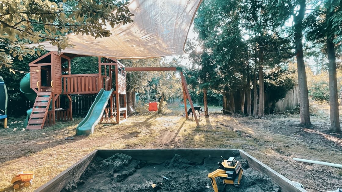 Epic playground with swing set, sandbox, slides and trampoline.