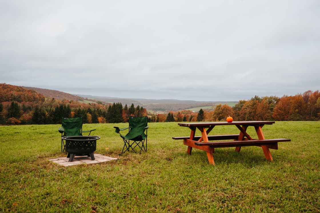 Down the ridge from the cabin is another set up ready for guests to use. Including a picnic table, chairs and fire pit. With even better views of the valley below.